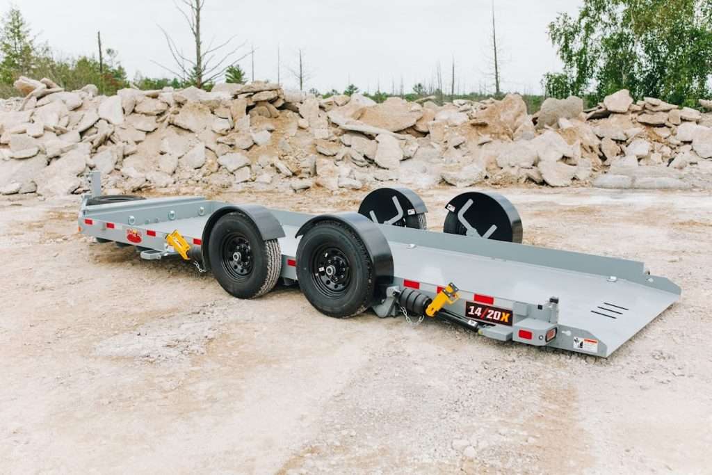 ants 4 14/20X Drop Deck Trailer Designed to meet your hauling needs with exceptional performance and reliability. With a load angle of 3 degrees on the bed and 9 degrees on the ramp, this trailer ensures smooth and efficient loading and unloading of your cargo. With a Gross Axle Weight Rating (GAWR) of 14,000 lb and a robust construction, it can handle heavy loads with ease.