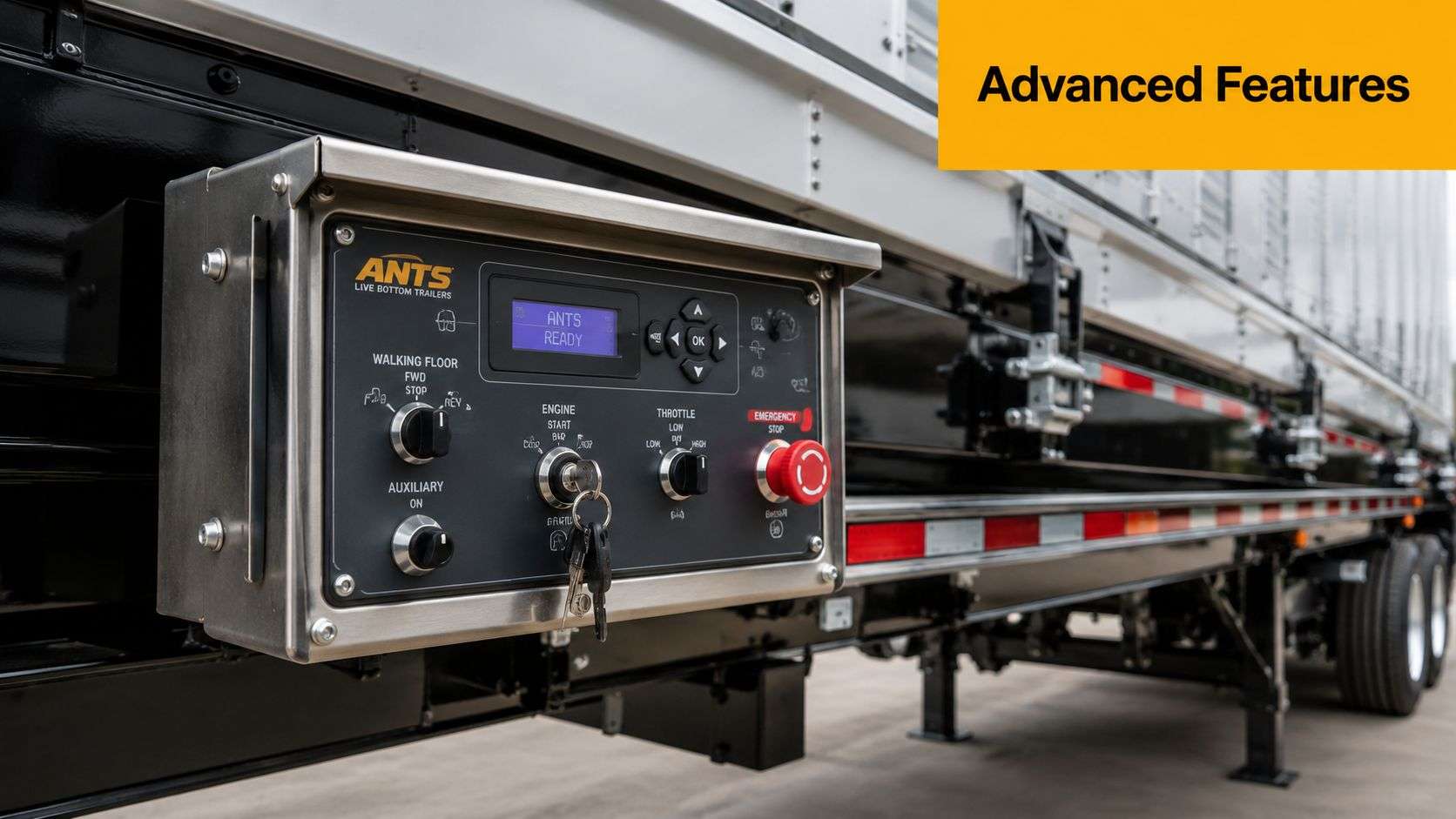 A close-up shot of an industrial control panel mounted on the side of a live bottom trailer.